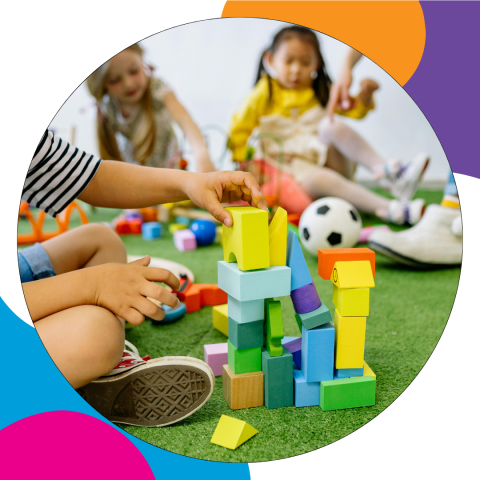 Group of young children playing with building blocks